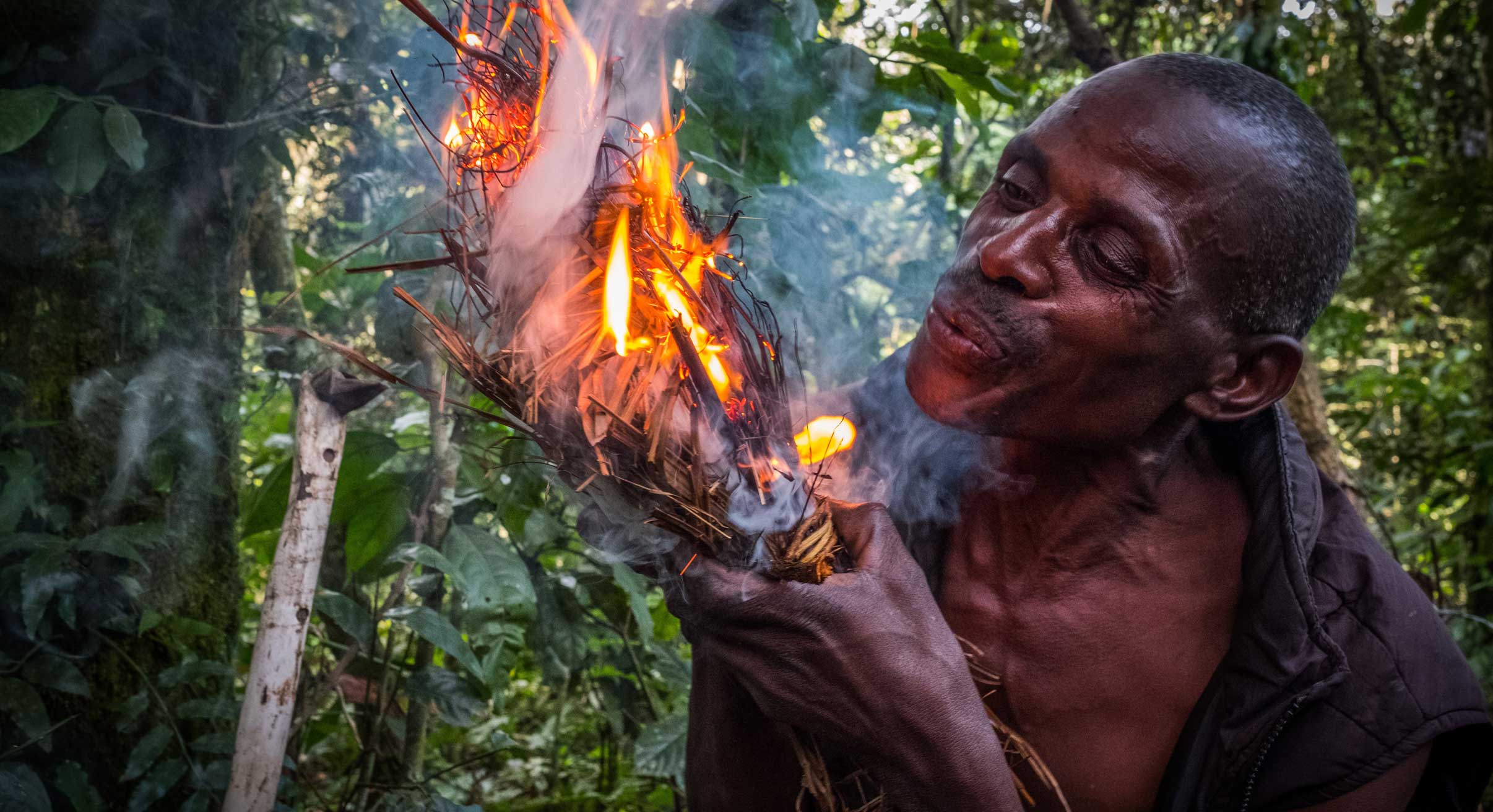 Batwa community starting a fire in Uganda
