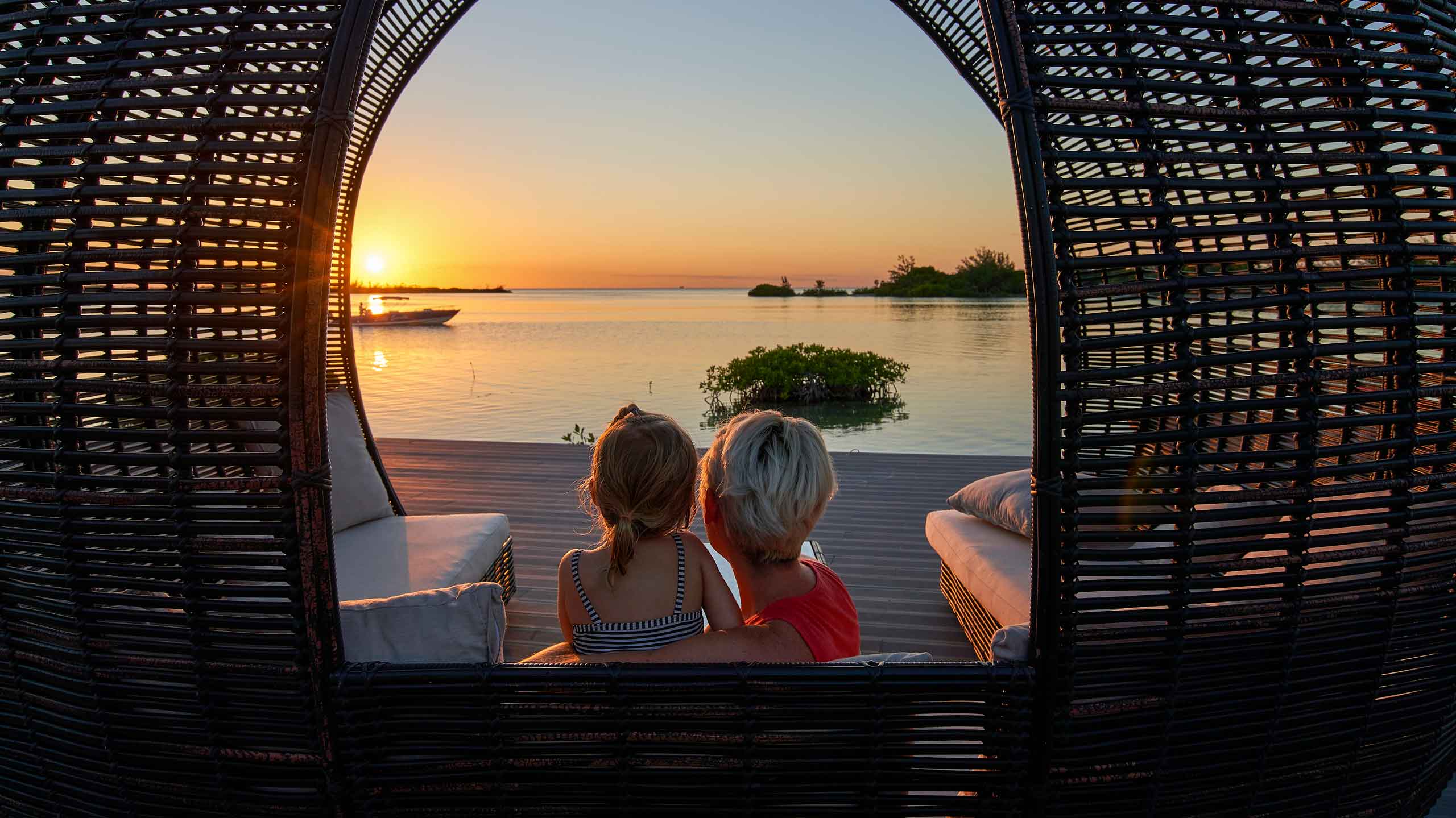 Family holiday in Belize - mother and daughter gazing at sunset
