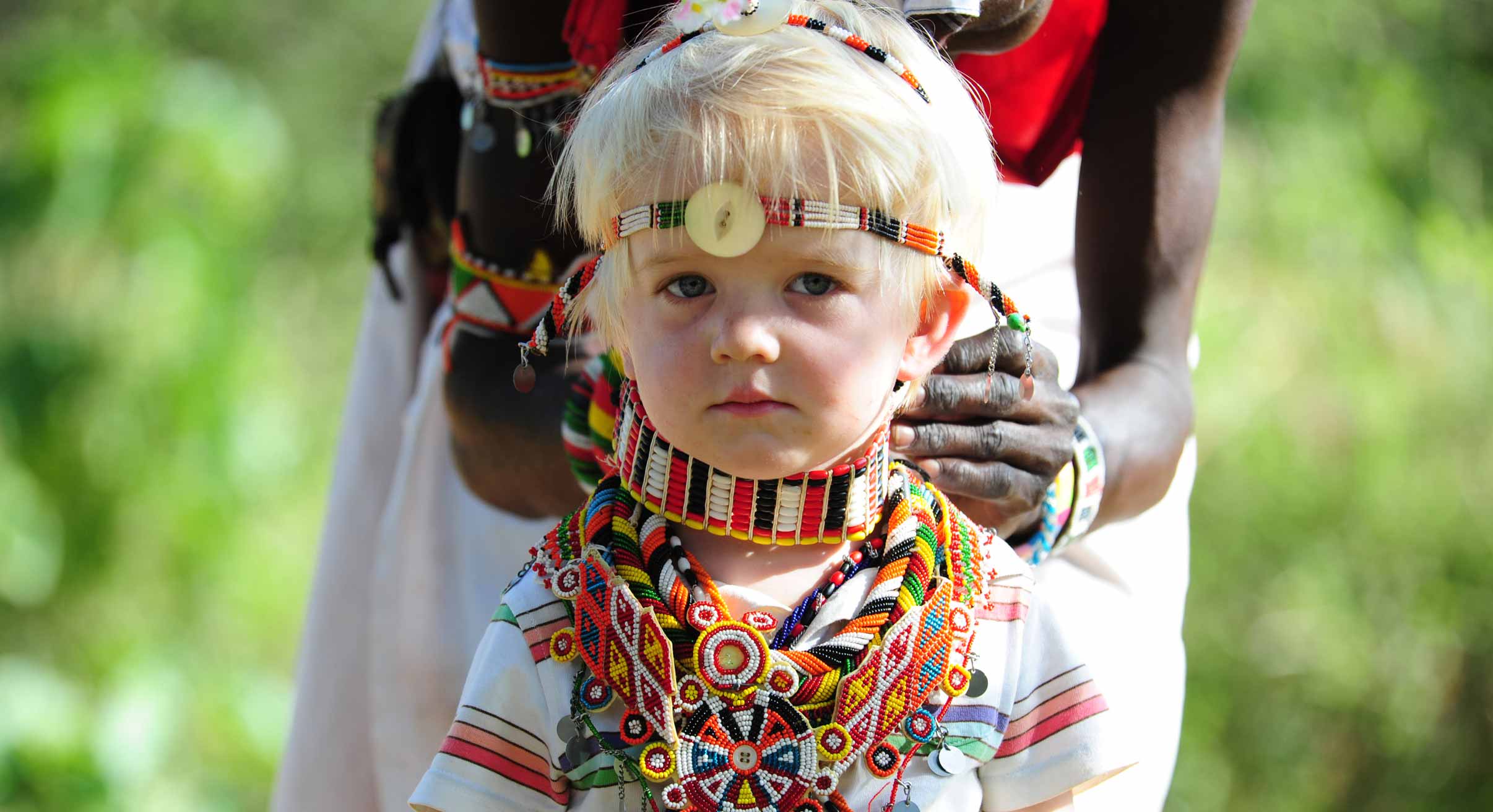 Child in Masai dress on Kenya camel safari