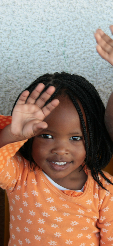 Child waving at camera in Cape Town, South Africa