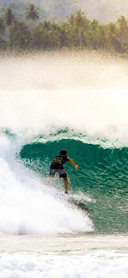 Surfing waves in the Mentawai Islands in Indonesa