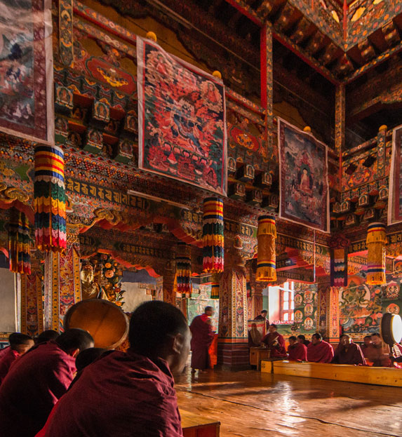 Monks praying in monastery in Gangtey, Bhutan