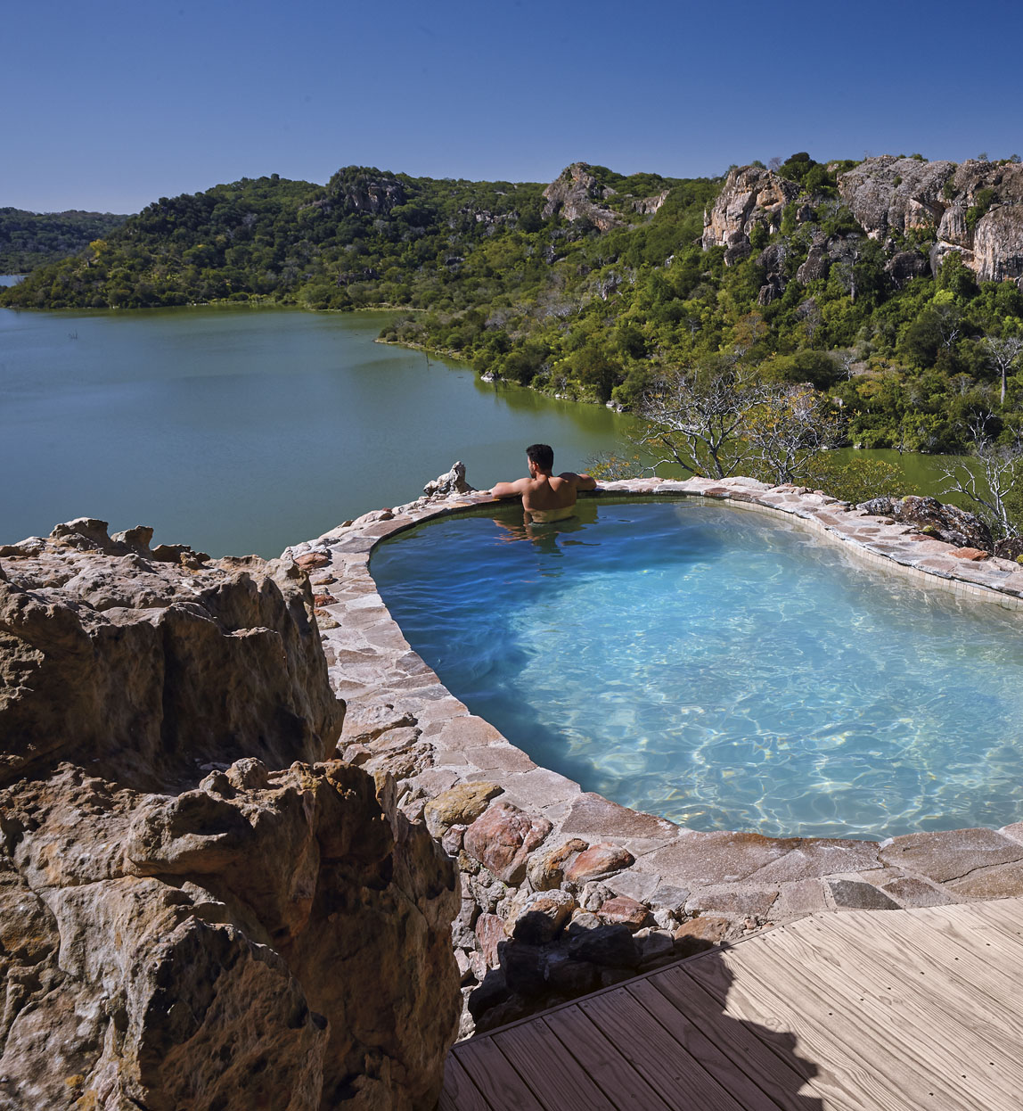 guest in plunge pool at singita pamushana