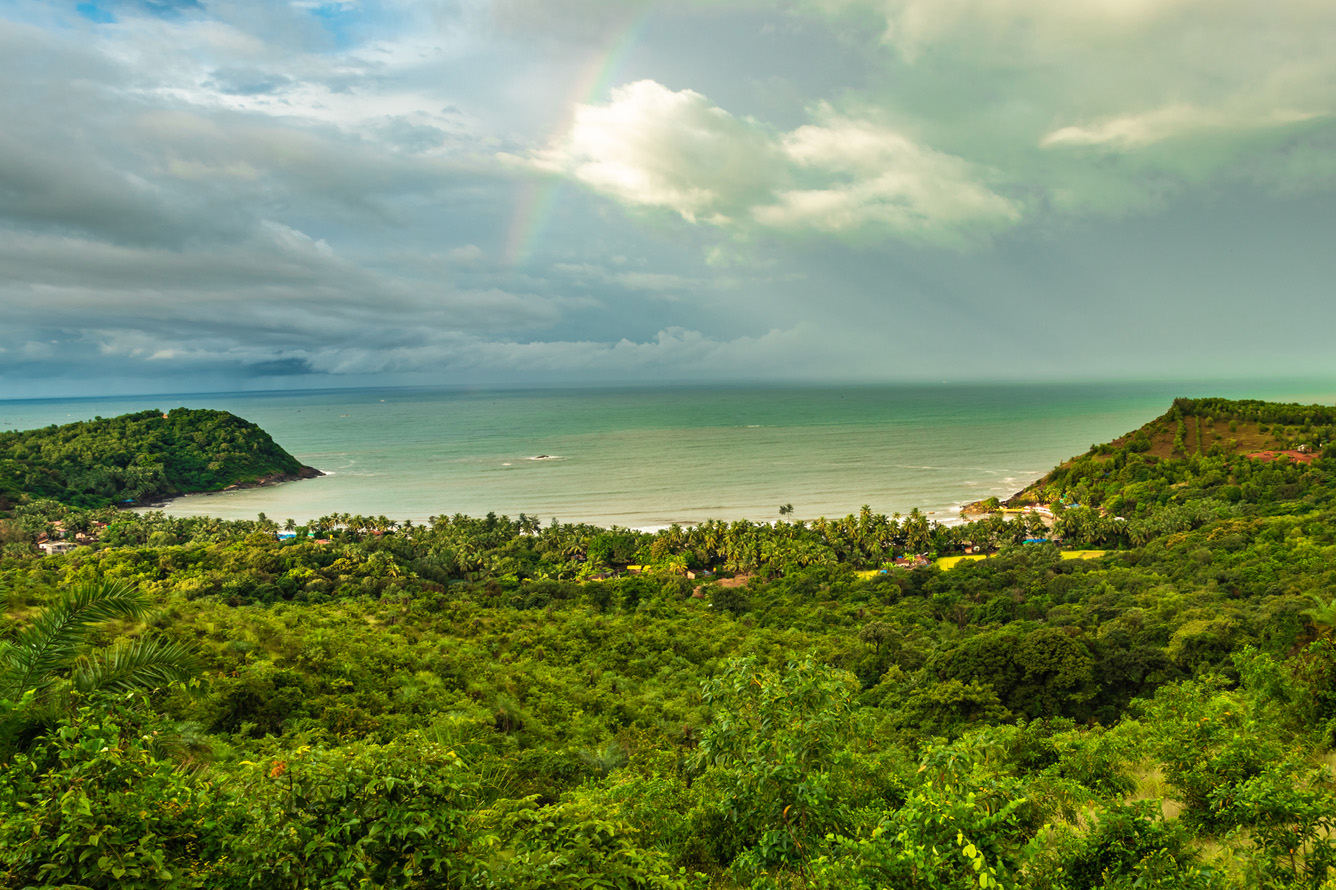 landscape with dense green forests overlooking gokarna karnataka india from mountain top.