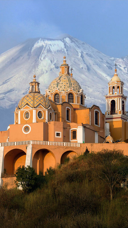 popocatepetl volcano and church on a hill in mexico
