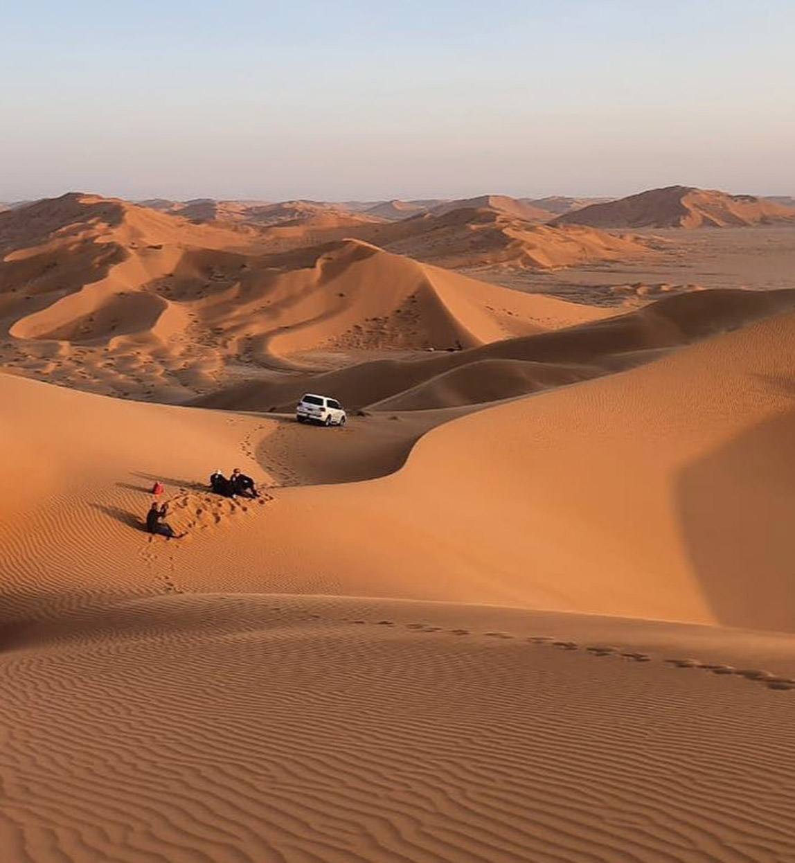 driving through dunes in the desert in oman