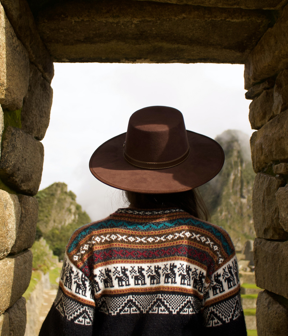 woman stood in archway at machu picchu