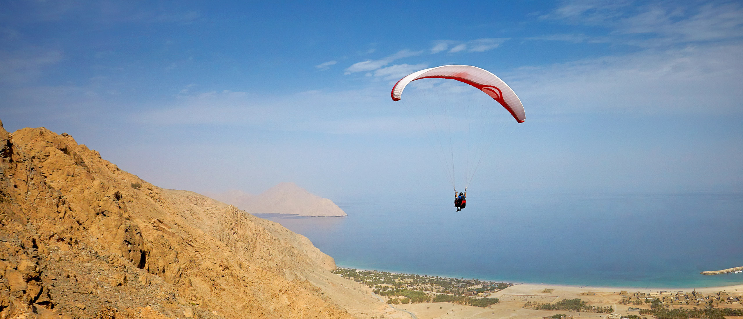 paragliding into zighy bay oman