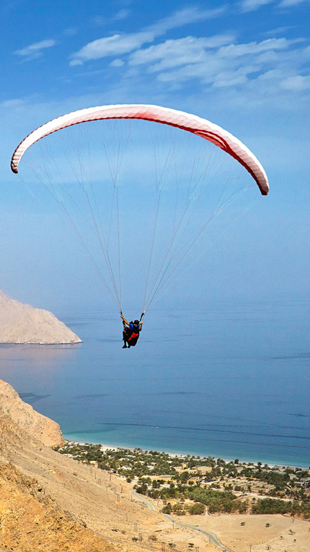 paragliding into zighy bay oman