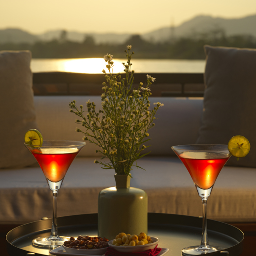 sunset cruise on mekong river in vietnam with cocktails