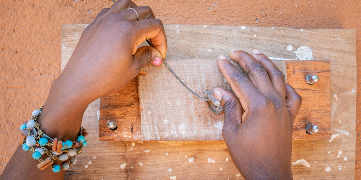coiling snare wire on a wooden tool