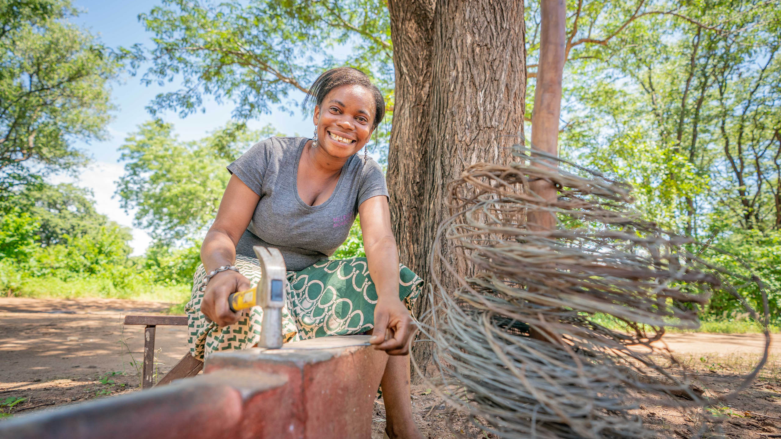 zambian woman creating jewellery from snare wire at mulberry mongoose