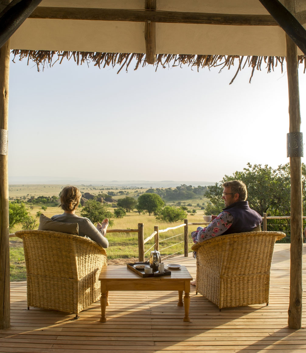 couple sat on verandah at mkombes house in tanzania