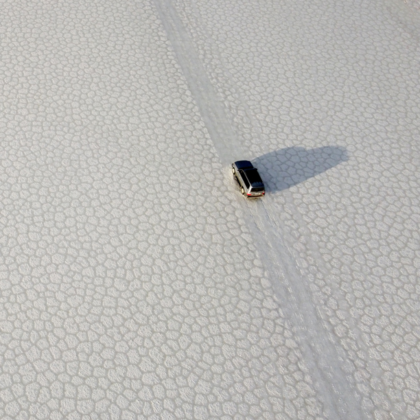 view of a jeep 4x4 driving through the salt flats in uyuni bolivia