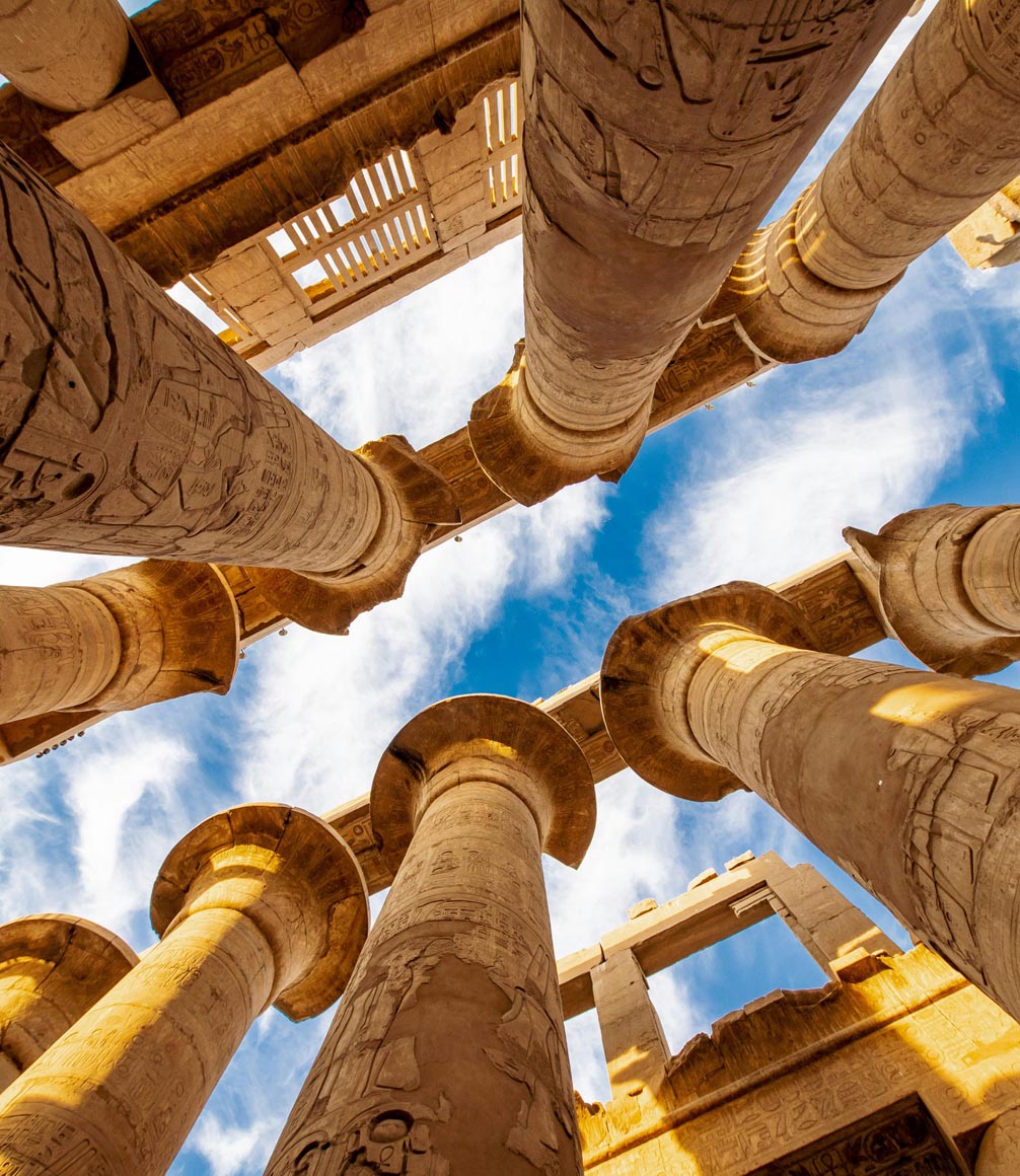 view through the pillars of a luxor temple towards the sky