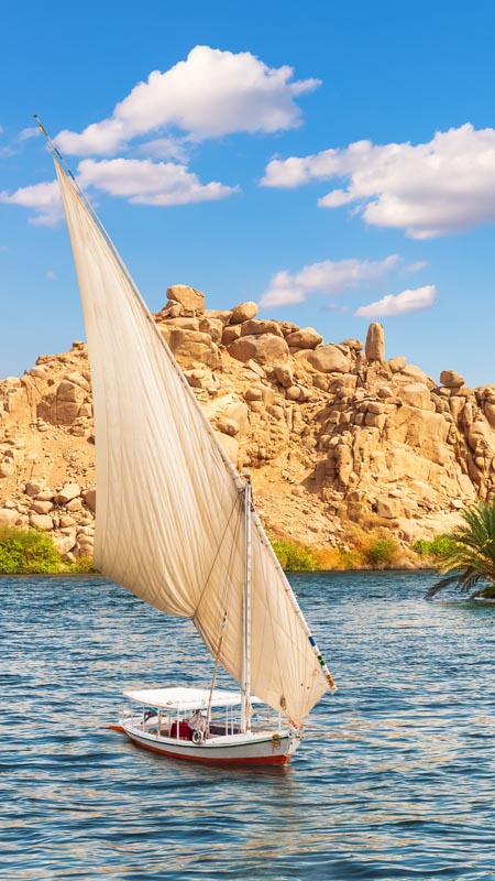 Felucca by the Temple of Philae on the Agilikia island, the Nile, Aswan, Egypt.