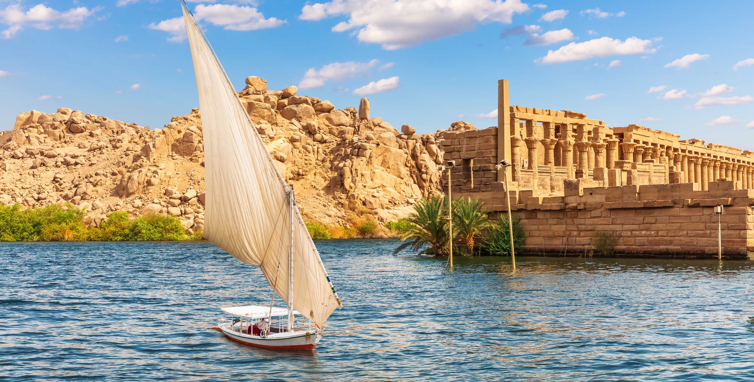 Felucca by the Temple of Philae on the Agilikia island, the Nile, Aswan, Egypt.