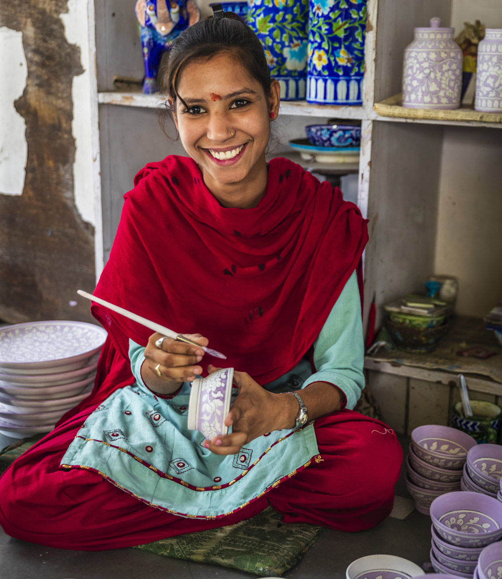 Blue Pottery being painted by jaipur craftswoman.