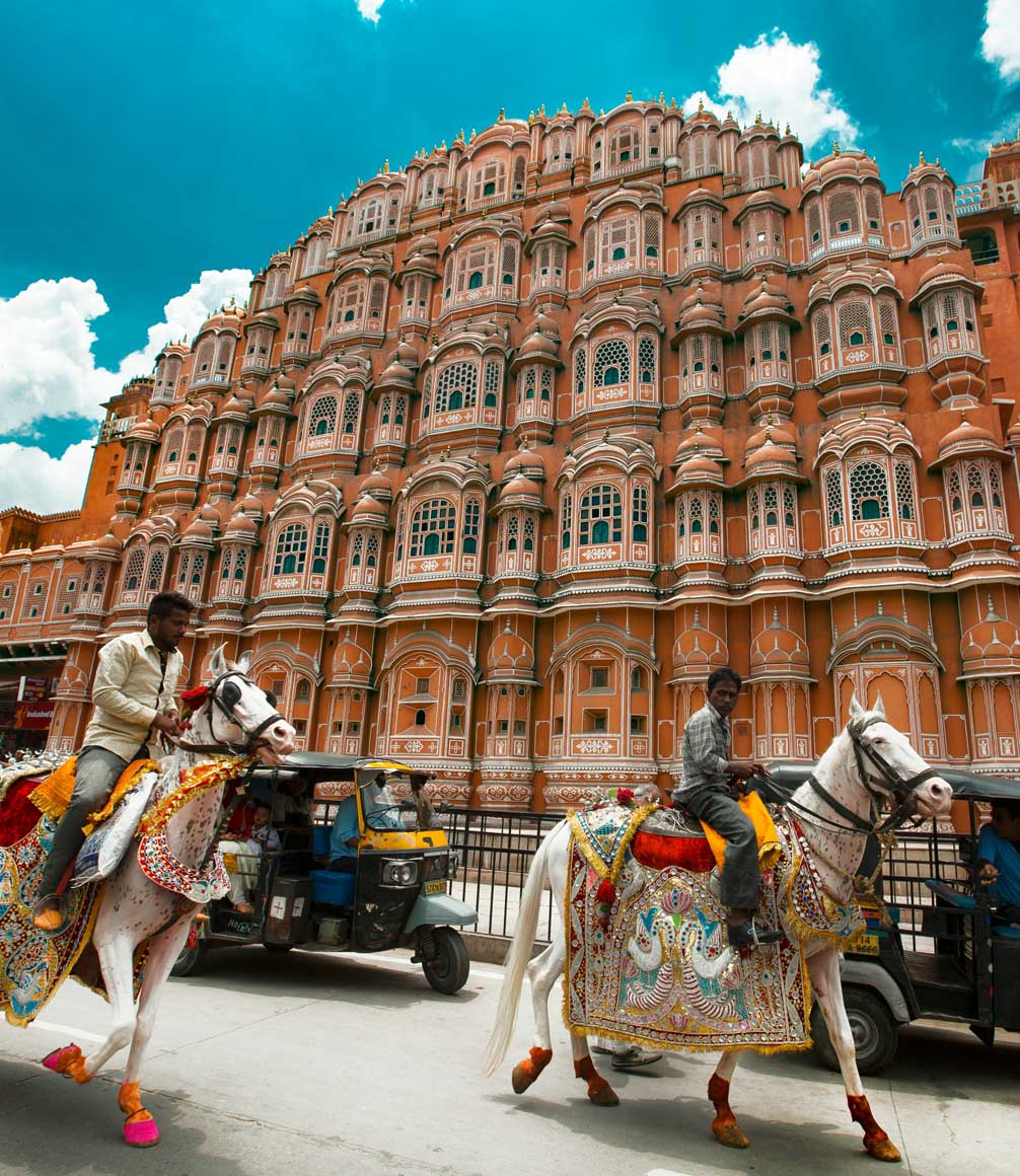 jawa mahal palace from the road outside with horses and tuktuks