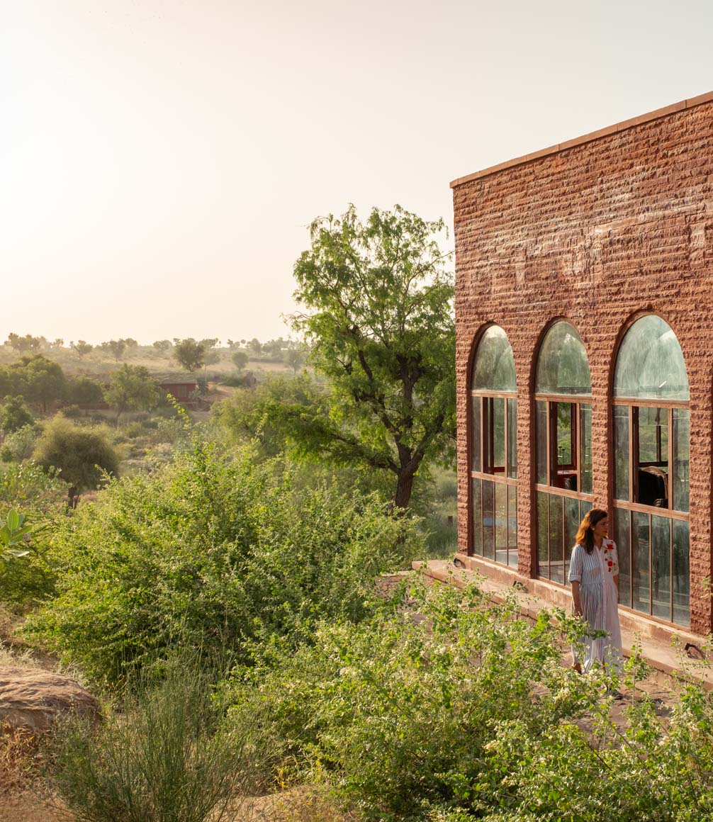 exterior of kaner retreat with guest walking in the gardens