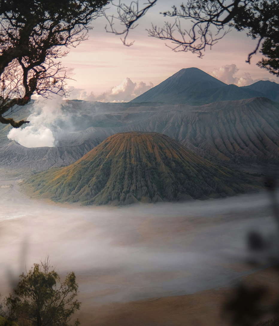sunrise over mount bromo volcano in indonesia with mist in the valley below