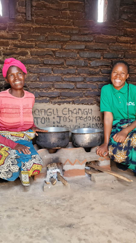 family with their fuel efficient cookstove in malawi