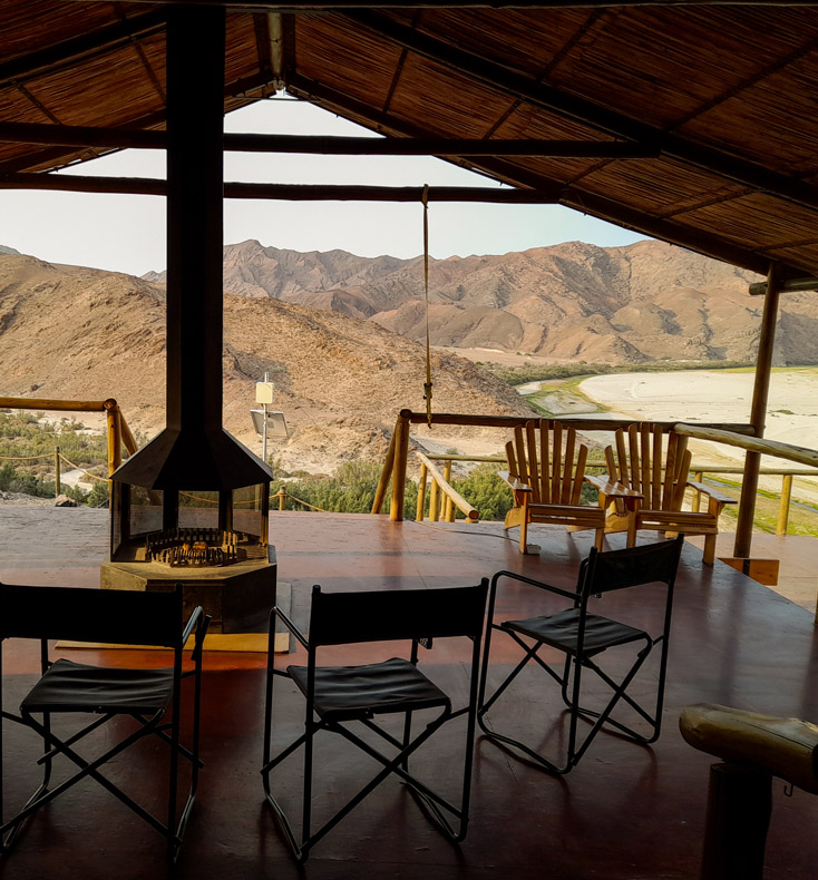 tented camp guest chairs looking out to the landscape of namibia's skeleton coast