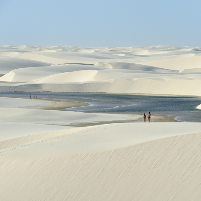 tourists walking in Lencois Maranhenses National Park, Brazil