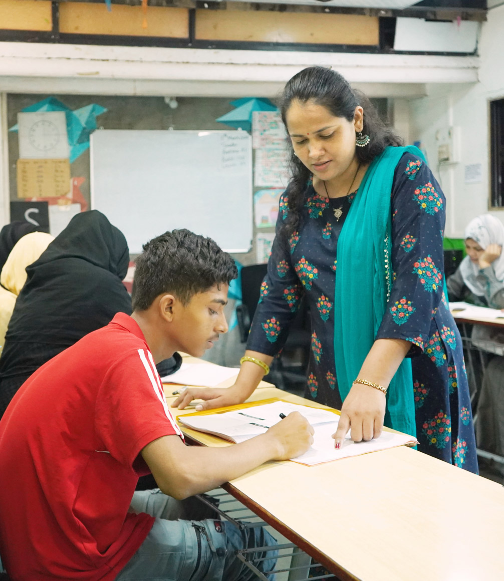 reality gives teacher in classroom with student