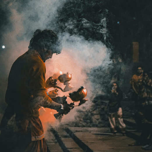 man performing aarti ceremony in rishikesh india