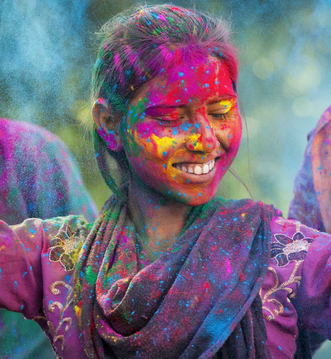 young woman covered in coloured dye at Holi festival in Jaipur