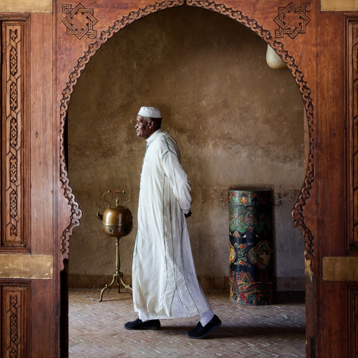 man in traditional dress in morocco building