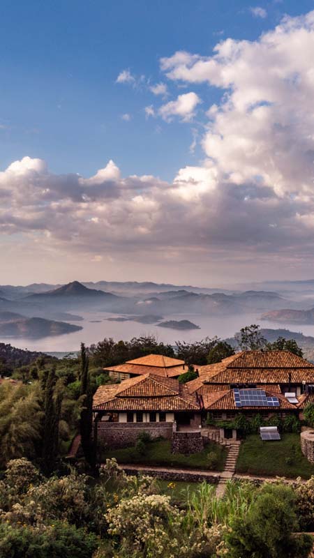 view of twin lakes in rwanda with lodge in the foreground and a cloud inversion between the mountains