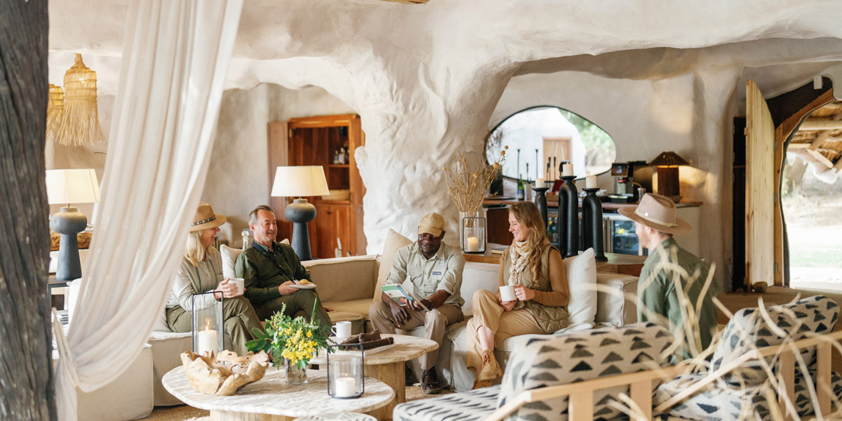 guests relaxing in interior of chongwe river house