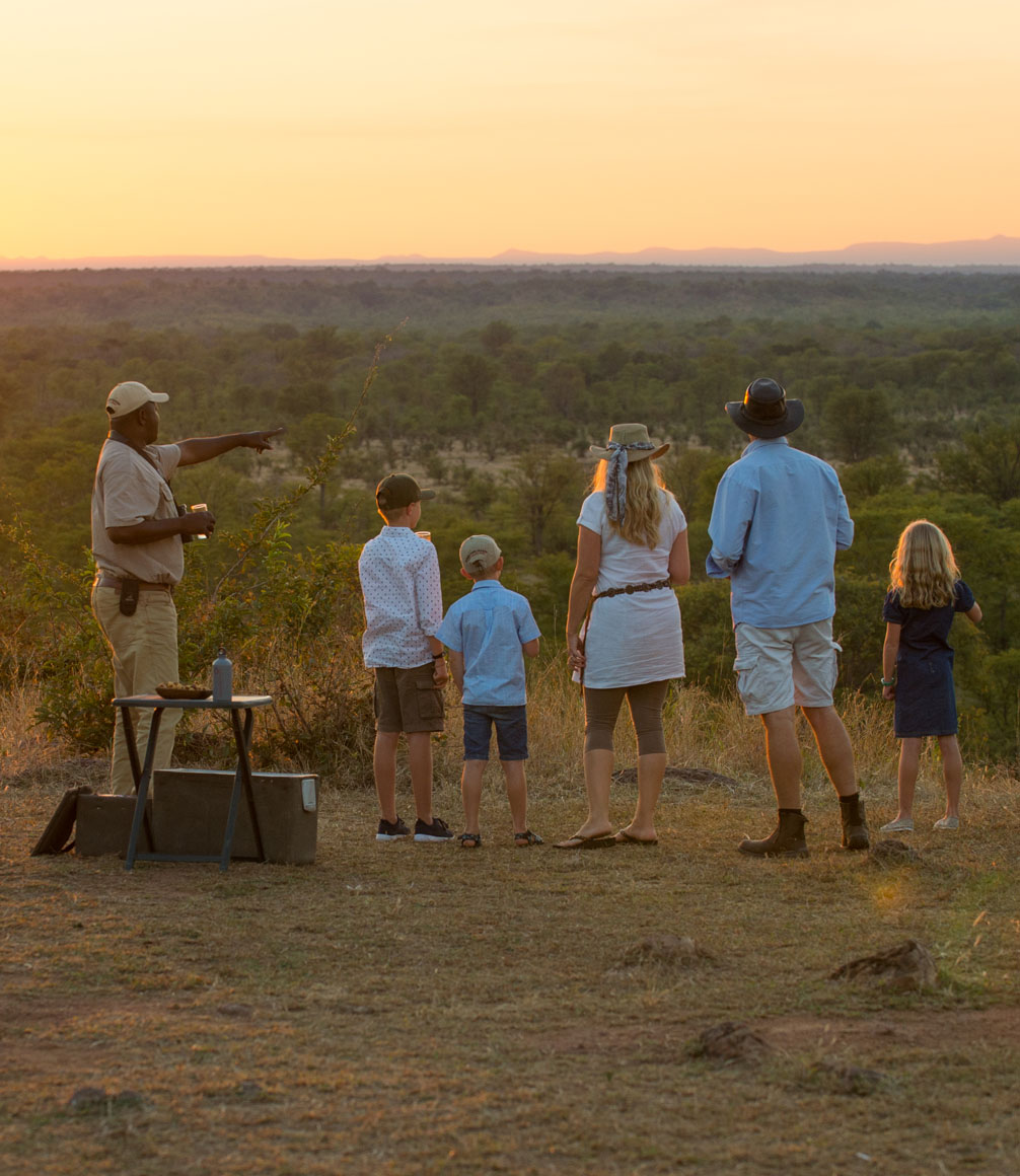 family overlooking the south luangwa landscape with guide on zambia family safari