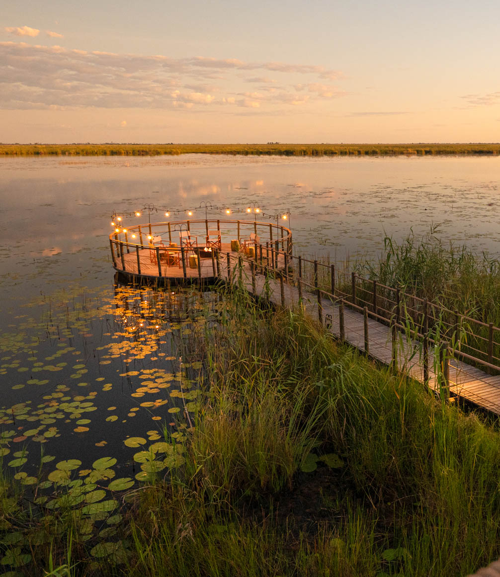 decking over a lagoon in the okavango delta at sunset