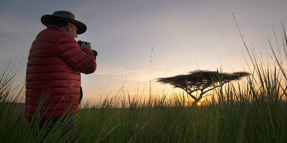 guest on a photographic safari taking a photo of wildlife