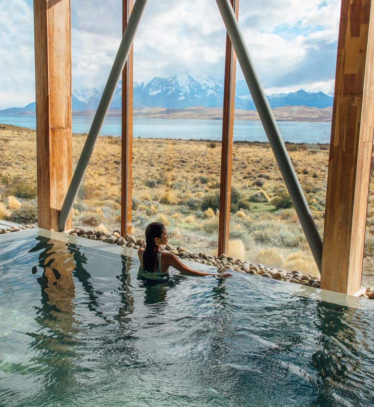 woman in pool overlooking in the patagonian landscape at tierra patagonia