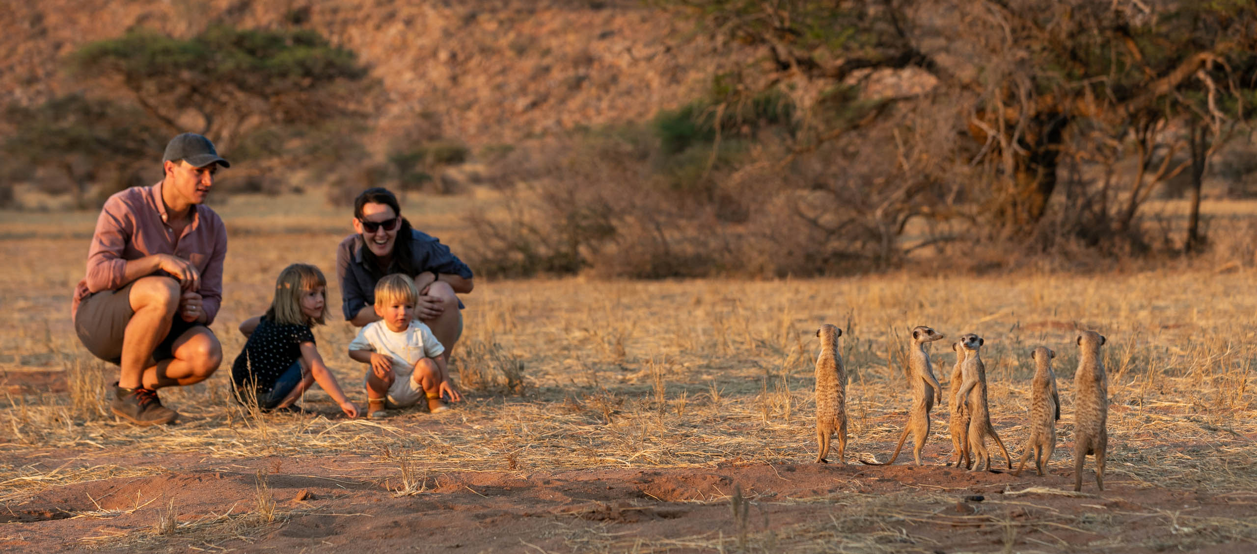 young family observing meerkats at tswalu in south africa - Image by Caitlin Smit