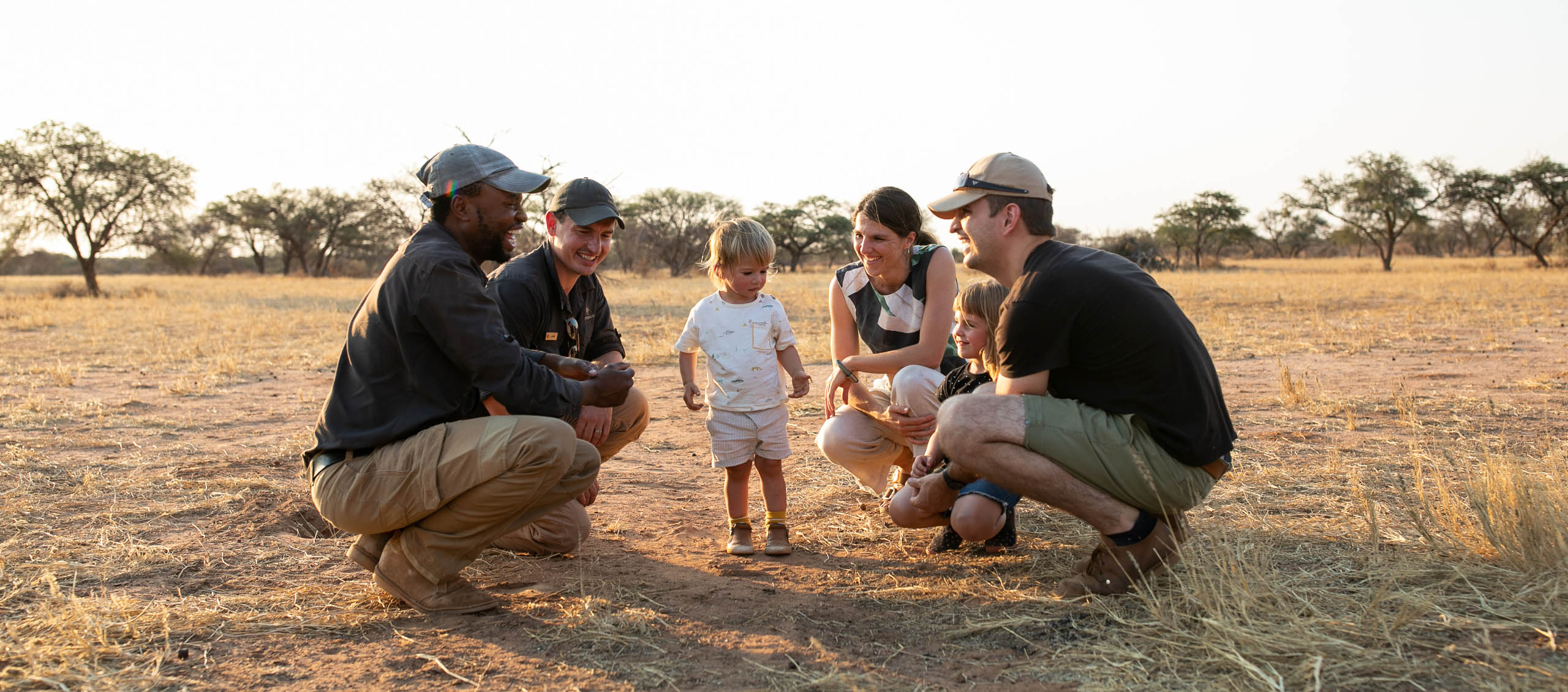 family on safari at tswalu in south africa, with rangers explaining the bush - Image by Caitlin Smit