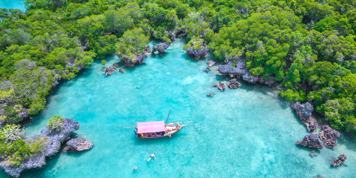 aerial view of the coastline of pemba island off zanzibar with a boat moored in the bay