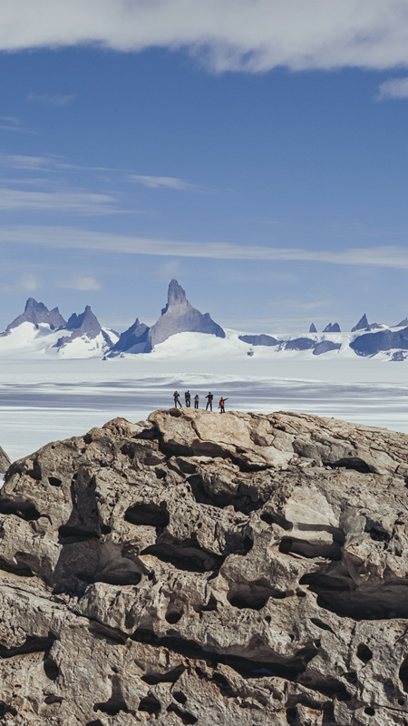 view of antarctica landscape with guests on mountaintop