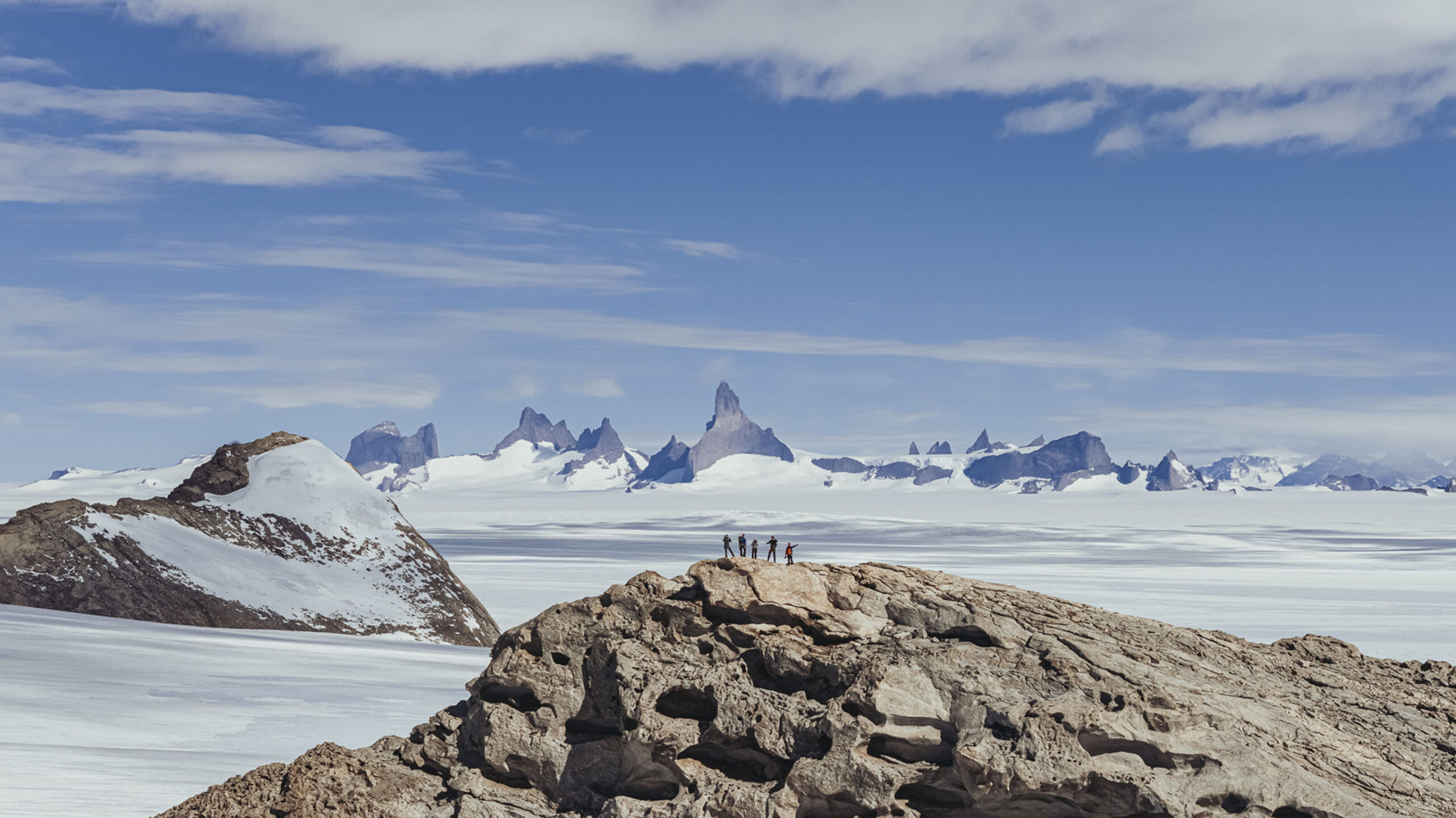 view of antarctica landscape with guests on mountaintop