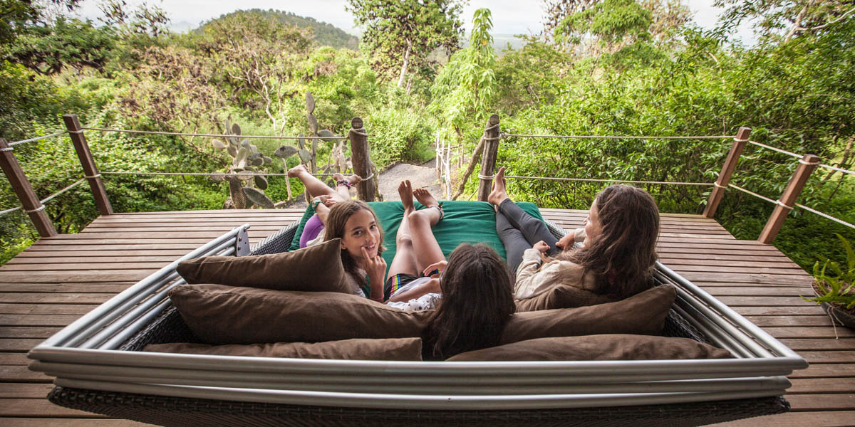 family lounging on galapagos safari camp verandah