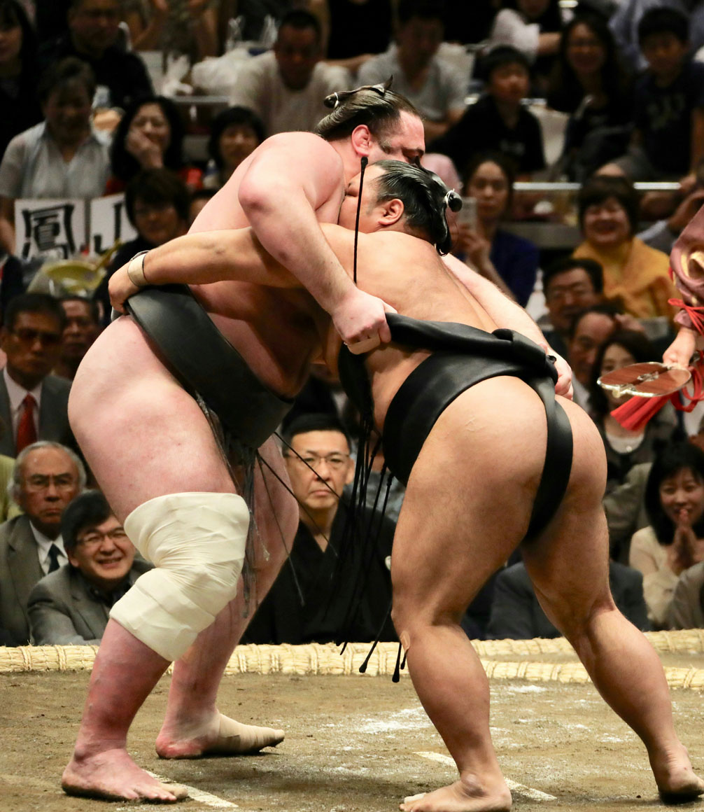 sumo wrestlers in the ring at the tournament in tokyo