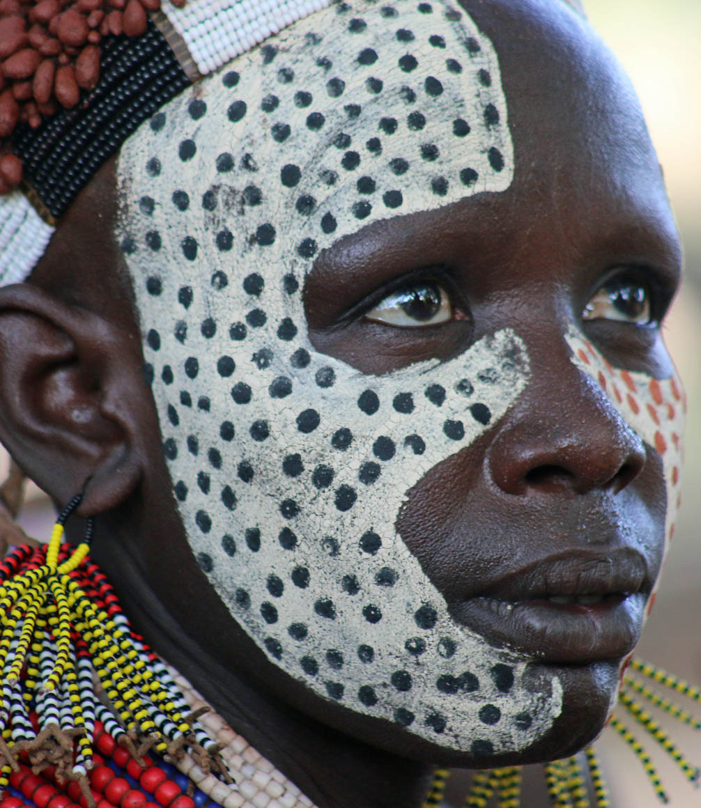 a person of the karo tribe with face painted