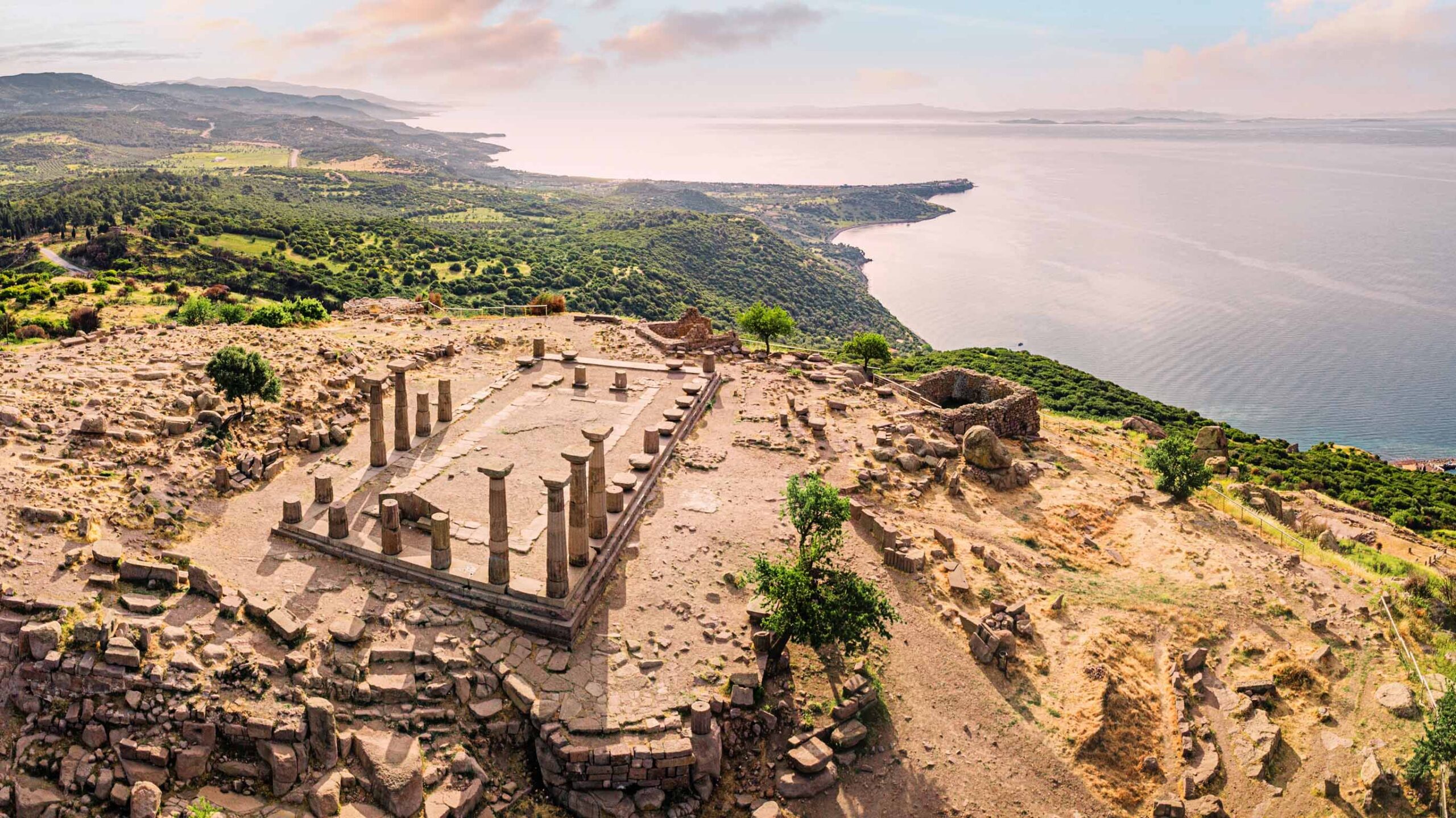 the ruins of athena's temple overlooking the coastline at assos in turkey