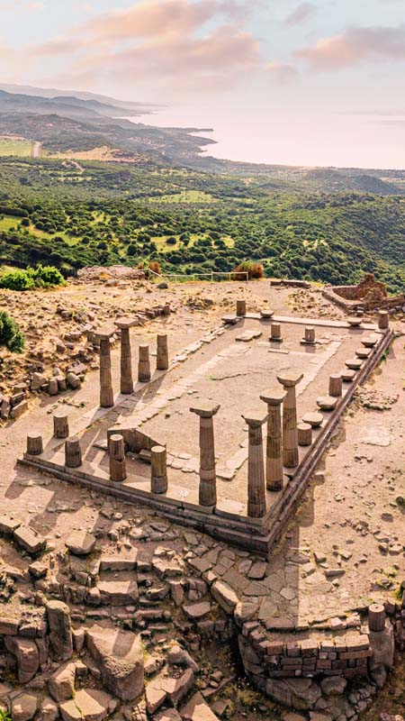 the ruins of athena's temple overlooking the coastline at assos in turkey