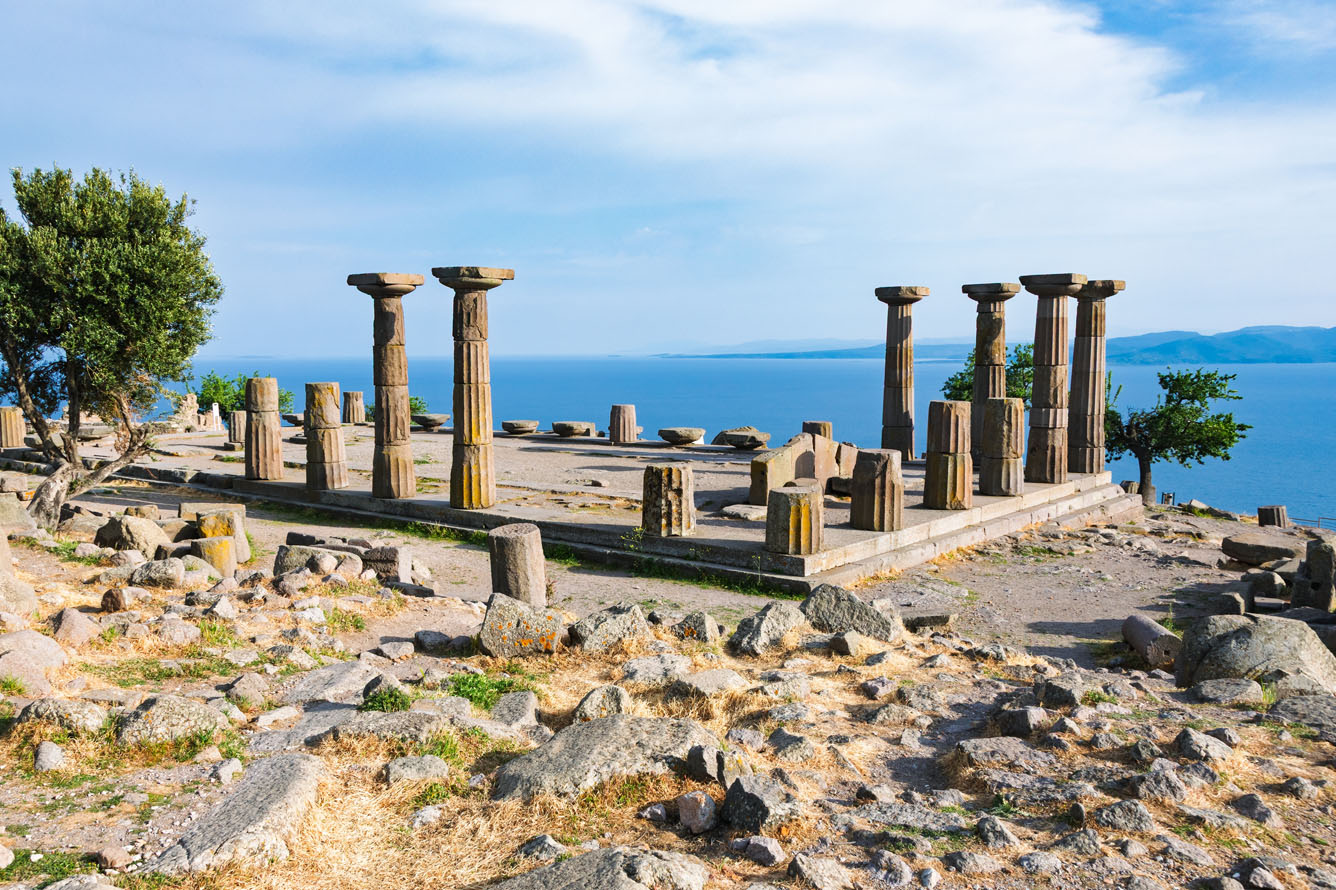 the ruins of athena's temple overlooking the coastline at assos in turkey
