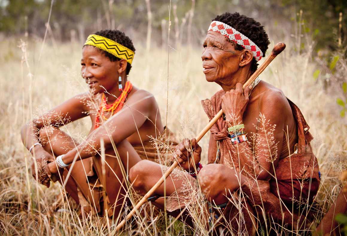 san bushmen of the makgadikgadi pans sat amongst the grasses